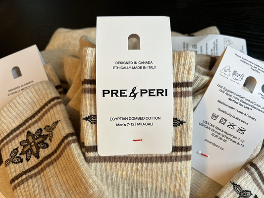 A closeup of a hang tag for socks that were designed in Canada and made ethically in Italy.